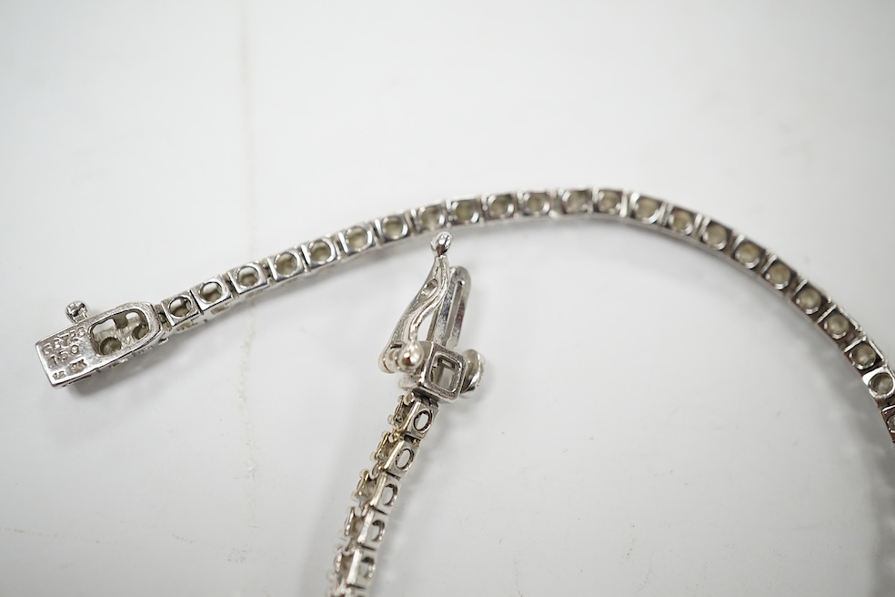 A modern 9ct white metal and diamond set tennis bracelet, with a total diamond weight of 1.50ct, 17.3cm, gross weight 6.6 grams. Condition - good